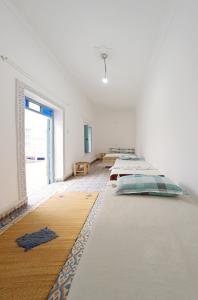a room with several beds in it with a window at Hostel BE 20 in Marrakech
