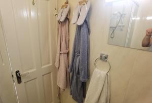 a bathroom with towels hanging on a door at TravelMore in Letterkenny