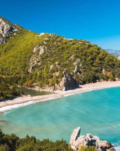 a view of a beach with people in the water at Sheriff, Olympos in Kumluca