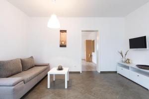 a living room with a couch and a table at Apartmani LAURA Krk in Krk