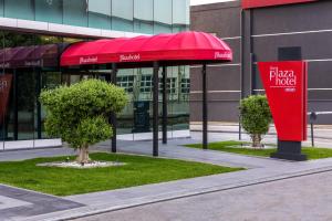 un parapluie rouge devant un bâtiment dans l'établissement The Plaza Hotel Edirne, à Edirne