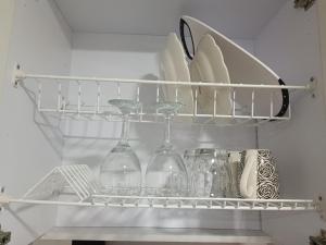 a shelf with wine glasses and other dishes in a refrigerator at Apto 202 in Cúcuta