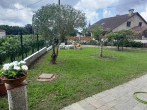 a yard with two trees and a house at RINCÓN DEL MIÑO in Tomiño