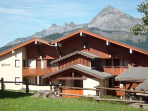 a large wooden building with a mountain in the background at Studio Crest-Voland, 2 pièces, 4 personnes - FR-1-733-56 in Crest-Voland