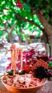 a plate of food on a table with a glass of wine at Sheriff, Olympos in Kumluca