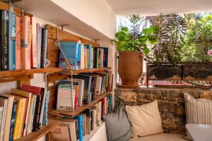 a room with bookshelves filled with books at Odyssey Suites in Poros