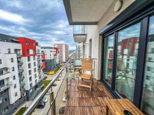 a balcony with a wooden chair on a building at Wooden Touch Studio in Braşov