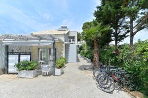 a group of bikes parked in front of a house at Alekos Luxury Suites Free 24h Transportation From - To Airport in Artemida