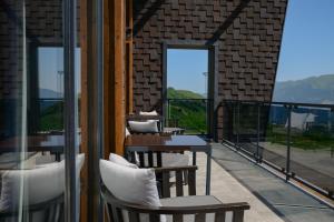 a row of tables and chairs on a balcony at Gudauri Lodge in Gudauri