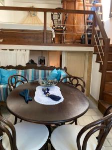 a dining room table with chairs and a bunk bed at Vera's traditional house - Chora in Serifos Chora