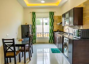 a kitchen with a table and a dining room at Royal Home Luxor Pool View in Luxor