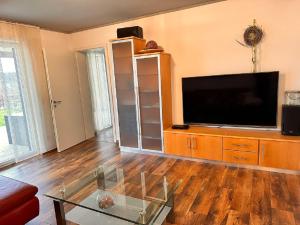 a living room with a flat screen tv and a entertainment center at Ferienwohnung Familie Nachtmann in Beilngries