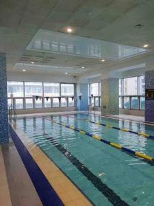 a large swimming pool in a large building at Haeundae Luxury House in Busan