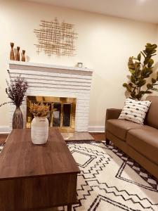 a living room with a couch and a fireplace at Newly renovated charming home with parking in Fort Washington