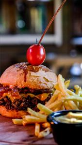 a hamburger and french fries with a cherry on top at Sheriff, Olympos in Kumluca