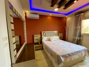 a bedroom with a bed and a blue light at سى فيو السريا in Alexandria