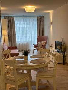 a living room with a table and chairs at Alka Boutique Apartments & SPA in Palanga