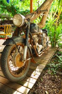an old motorcycle parked on a wooden deck at Sheriff, Olympos in Kumluca