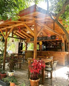 an outdoor restaurant with wooden tables and chairs at Sheriff, Olympos in Kumluca