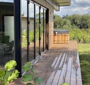 a patio with a grill on the side of a house at Eco Lodge "Deben" with Private Hot Tub in East Bergholt