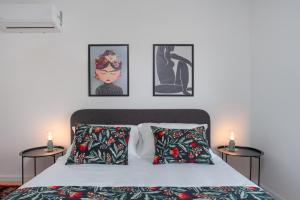 a bedroom with a bed and three pictures on the wall at Villa Dream Island in Paljuv +65 photos