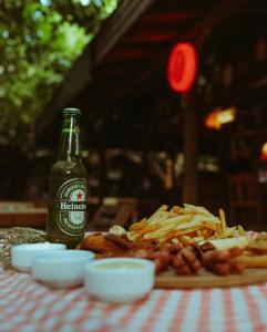 a table with a bottle of beer and a plate of food at Sheriff, Olympos in Kumluca