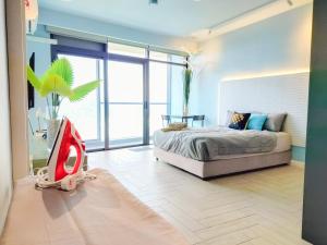 a bedroom with a bed and a large window at Empire City PJ Studio Suites by Manhattan Group in Petaling Jaya +21 photos