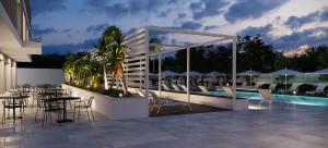 a patio with a table and chairs and a pool at B21 Lifestyle Hotel in Bari