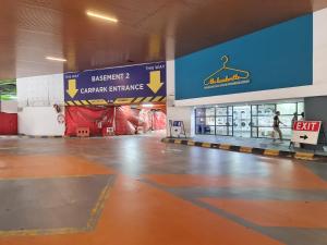an empty shopping mall with a person walking through a store at Empire City PJ Studio Suites by Manhattan Group in Petaling Jaya