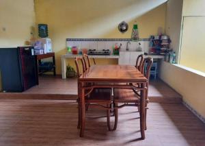 a wooden table and chairs in a kitchen at Anindya House in Magelang