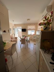a kitchen and living room with a table and chairs at Maria's guesthouse in Batsi +12 photos
