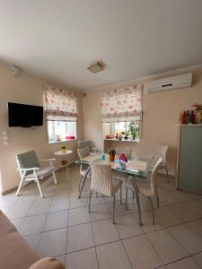 a living room with a table and chairs at Maria's guesthouse in Batsi
