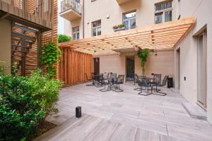 a patio with chairs and tables in a building at Aparthotel Rimska 14 in Prague +108 photos