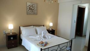 a bedroom with a bed with a doll on it at Kos Villa - Family Comfort with large Garden, Jacuzzi in Kos