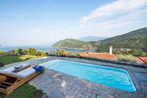 a swimming pool with a view of the ocean at Nafsika Residences ex Petra Mare Village in Kerveli