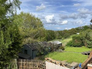a view of a backyard with a fence and a house at Beautiful 3 Bed House with Hot Tub in Blaydon Burn 