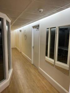 an empty room with windows and a hallway at Bigg Market Apartments in Newcastle upon Tyne