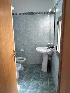 a bathroom with a sink and a toilet at HOUSE MIRIAM in Reggio Calabria