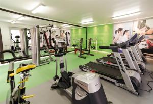 a gym with tread machines and people in the background at Departamento Ipanema in Temuco