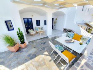 a living room with a table and chairs at Sylvia's Villa in Imerovigli