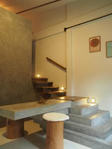 a room with stairs and a bench with a stool at Makai NAP in Ban Lam Pi