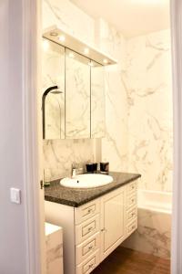 a white bathroom with a sink and a mirror at New - cosy & nice Apartment in Palais Miramar in Cannes