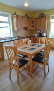a kitchen with a wooden table and chairs at Beech cottage 