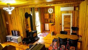 a living room with wood paneling and a wood stove at HAT NATUREL RESORT Sapanca in Sapanca