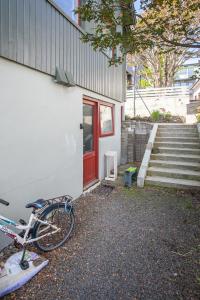 a bike parked next to a building with a red door at Studio Apartment / 20min From City Center / Tórshavn in Tórshavn