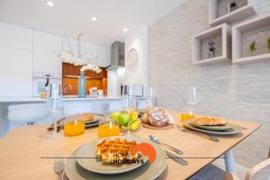 a dining room table with a plate of food on it at #085 Pool View, Center City with AC in Albufeira