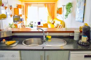 a kitchen with a sink and a counter top at Komfortable Ferienwohnung erste Strandreihe Playa Burriana in Nerja +17 photos