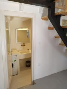 a bathroom with a sink and a mirror at Oniropagida Nisyros apartments #2 Nikia view in Nikiá