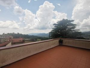 a balcony with a view of the mountains at Villetta Il Nespolo in Barberino di Mugello