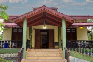 a house with a staircase leading to the front door at Wandr Zen in Khopoli